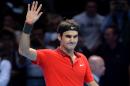 Switzerland's Roger Federer celebrates winning his singles group B match against Canada's Milos Raonic on the first day of the ATP World Tour Finals tennis tournament in London on November 9, 2014