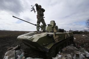 A Ukrainian soldier stands atop an armored vehicle&nbsp;&hellip;