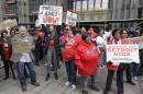 Teachers rally outside the school district's headquarters, Tuesday, May 3, 2016, in Detroit. Nearly all of Detroit's public schools were closed for a second consecutive day Tuesday after hundreds of teachers called out sick over concerns that many may not get paid if the financially struggling district runs out of money. (AP Photo/Carlos Osorio)