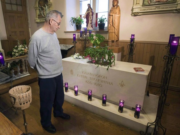 In this December 19, 2011, photo, deacon Ron Boyer looks at the tomb of Kateri Tekakwitha at St. Francis Xavier Church, in Kahnawake, Que. The woman who is credited with life-saving miracles is set to become North America's first aboriginal saint. Kateri Tekakwitha is to be canonized by the Pope at a Vatican mass on Sunday, Oct. 21, 2012. (AP Photo/The Canadian Press, Ryan Remiorz)