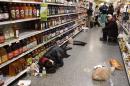 People rest at the aisle of a Publix grocery store after being stranded due to a snow storm in Atlanta