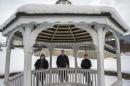 In this Feb. 3, 2015 photo, from left, Beth Peeler, 16, teacher Bill Curtin and Magdalena Garcia, 17, from Kankakee High School pose at a gazebo in Kankakee, Ill., before its planned demolition. In 1999, after Places Rated Almanac called Kankakee the worst metropolitan area to live in the U.S. and Canada, talk-show host David Letterman poked fun with a Top 10 list and sent the town two gazebos to spruce things up. Now students are dismantling the gazebos and making a commemorative rocking chair out of the wood for Letterman's retirement. (AP Photo/Chicago Tribune, Zbigniew Bzdak) MANDATORY CREDIT, CHICAGO SUN-TIMES OUT, DAILY HERALD OUT, NORTHWEST HERALD OUT, DAILY CHRONICLE OUT, THE HERALD-NEWS OUT, THE TIMES OF NORTHWEST INDIANA OUT, NEW YORK TIMES OUT, TV OUT, MAGS OUT, NO SALES