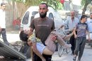 A man carries the body of a child allegedly killed by a pro-government forces sniper in the northern Syrian city of Aleppo on October 2, 2013