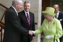 Britain's Queen Elizabeth shakes hands with Northern Ireland deputy first minister Martin McGuinness at the Lyric Theatre in Belfast