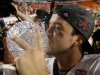 Alabama's AJ McCarron kissed The Coaches' Trophy after the BCS National Championship college football game against Notre Dame Monday, Jan. 7, 2013, in Miami. Alabama won 42-14. (AP Photo/David J. Phillip)