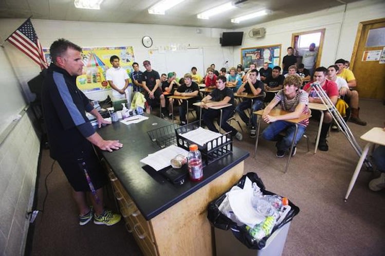 Union High football coach Matt Labrum speaks to his players after a community service outing -- Deseret News