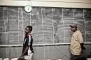 Madagascans wait to mark votes on the board at a polling station in Antananarivo on October 25, 2013