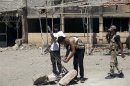 Free Syrian Army fighters prepare to launch homemade rockets in an offensive attack against forces loyal to Syria's President Assad in Deir al-Zor
