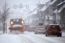 A snow-plough clears the street in Winterberg, western Germany, Saturday Dec. 27, 2014. Weather forecasts predict more snowfall. (AP Photo/dpa, Marius Becker)