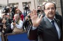 French President Francois Hollande, right, waves to journalists as he arrives for an EU summit in Brussels on Thursday, June 27, 2013. European Union leaders meet in Brussels ostensibly to agree on ways to find more jobs for the young, who've been disproportionately punished by years of crisis and recession. (AP Photo/Geert Vanden Wijngaert)