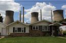 The John Amos coal-fired power plant is seen behind a home in Poca