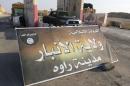 A banner is placed at checkpoint belonging to militant group Islamic State, at main entrance of Rawah in Anbar province