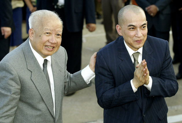 FILE - In this Oct. 20, 2004 file photo, Cambodia's King Norodom Sihanouk, left, introduces his son and successor, King Norodom Sihamoni upon their arrival at Phnom Penh airport, in Cambodia. Sihanouk, the former Cambodian king who was never far from the center of his country's politics through a half-century of war, genocide and upheaval, has died. He was 89. (AP Photo/Andy Eames, File)