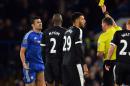 Chelsea's striker Diego Costa (L) receives a yellow card from referee Andre Marriner during an English Premier League football match against Watford on December 26, 2015