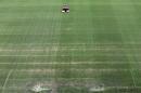 A groundsman cuts the grass at the 2014 soccer World Cup venue at the Arena da Amazonia in Manaus, Brazil, Wednesday June 11, 2014. (AP Photo/Themba Hadebe)