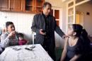 Leonarda Dibrani (R), the 15 year-old Roma schoolgirl whose deportation from France sparked a huge outcry, sits with her mother Xhemaili (L), her father Resat Dibrani and her sister Medina at their temporary home in Mitrovica on October 19, 2013