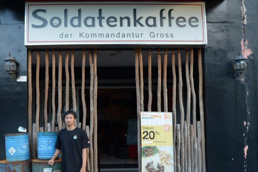 This picture taken on July 16, 2013 shows owner Henry Mulyana outside his "Soldiers' Cafe" in Bandung, Indonesia