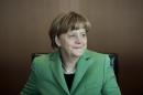 German Chancellor Angela Merkel smiles at the beginning of the weekly cabinet meeting of her government at the chancellery in Berlin, Wednesday, Jan. 28, 2015. (AP Photo/Markus Schreiber)