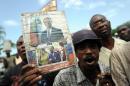 Supporters of former Haitian president Jean Bertrand Aristide protest in front of the Palace of Justice on August 13, 2014 in Port au Prince