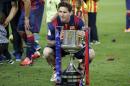 Barcelona's Lionel Messi poses with the trophy after winning the final of the Copa del Rey soccer match between FC Barcelona and Athletic Bilbao at the Camp Nou stadium in Barcelona, Spain, Saturday, May 30, 2015. (AP Photo/Manu Fernandez)