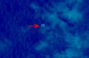 In this March 9, 2014 satellite image seen on the website of the Chinese State Administration of Science, Technology and Industry for National Defense, floating objects are seen at sea next to the red arrow which was added by the source. China's Xinhua News Agency reported Wednesday that the images show suspected debris from the missing Malaysia Airlines jetliner floating off the southern tip of Vietnam. (AP Photo/Chinese State Administration of Science, Technology and Industry for National Defense)