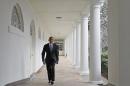 US President Barack Obama walks through the Colonnade on his way to the Oval Office of the White House on January 28, 2014 in Washington, DC