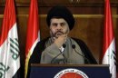 Iraqi Shiite cleric Moqtada al-Sadr listen to questions during a joint news conference in Arbil