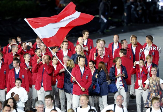 Austria's flag bearer Markus Rogan holds national flag in athletes parade during opening ceremony of London 2012 Olympic Games at Olympic Stadium