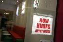 A sign in a window at a restaurant advertises for a job opening on December 6, 2013 in New York City