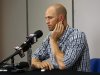 Toronto Blue Jays pitcher J.A. Happ gestures to his head during a press conference before a baseball game against the Tampa Bay Rays Wednesday, May 8, 2013, in St. Petersburg, Fla. Happ was speaking following his release from the hospital earlier in the day, after being hit by a line drive from Tampa Bay Rays' Desmond Jennings the previous night.  (AP Photo/Mike Carlson)
