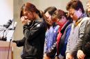 Relatives of the nine missing passengers of the sunken ferry Sewol cry during a news conference at a gym on South Korea's southwestern island of Jindo, where they have been staying at since the April 16 sinking of ferry Sewol, in Jindo, South Korea, Tuesday, Nov. 11, 2014. A South Korean court on Tuesday handed a 36-year prison sentence to the captain of a sunken ferry, saying he was professionally negligent and abandoned his passengers during the disaster in April that killed more than 300 people. (AP Photo/Yonhap, Park Chul-hong) KOREA OUT