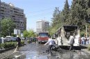 Firefighters work at the site of an explosion at al-Mezze neighbourhood in Damascus