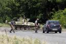 Ukrainian servicemen stop a car at a checkpoint outside the eastern Ukrainian town of Slaviansk