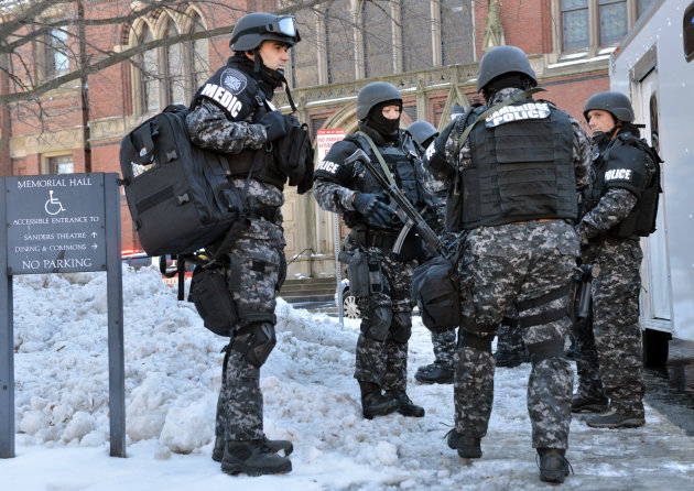 Tactical police assemble outside a building at Harvard University in Cambridge, Mass., Monday, Dec. 16, 2013. Four buildings on campus were evacuated after campus police received an unconfirmed report that explosives may have been placed inside, interrupting final exams. (AP Photo/Josh Reynolds)