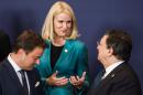 Denmark's Prime Minister Helle Thorning-Schmidt, center, talks with European Commission President Jose Manuel Barroso, right, and Luxembourg's Prime Minister Xavier Bettel during an EU summit at the European Council building in Brussels, Wednesday, July 16, 2014. European Union leaders disagreed Wednesday over who will get the prestigious job as the 28-nation bloc's new foreign policy chief to succeed Catherine Ashton, who also chairs the international negotiations on Iran's nuclear program. The horse-trading at the summit in Brussels to fill that and other top EU jobs was likely to run late into the night as leaders weighed the candidates' party affiliation, gender, political views and stance on Russia in particular. (AP Photo/Geert Vanden Wijngaert)