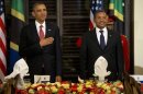 President Barack Obama and Tanzanian President Jakaya Kikwete stand for the national anthem during an official dinner at the State House in Dar Es Salaam, Tanzania, Monday, July 1, 2013. The president is traveling in Tanzania on the final leg of his three-country tour in Africa. (AP Photo/Evan Vucci)