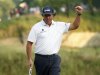 Phil Mickelson of the U.S. reacts after his birdie on the 17th green to take the lead during the third round of the 2013 U.S. Open golf championship at the Merion Golf Club in Ardmore