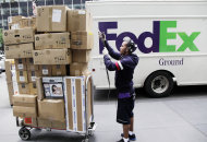 <p>               In this Friday, May 11, 2012, file photo, a FedEx worker sorts boxes for delivery as they are unloaded from a FedEx truck in New York. FedEx Corp. said Tuesday, June 19, 2012, that slow global growth will crimp its earnings results over the next 12 months, but it’s vowing to make significant cost cuts to make up for any shortfall.(AP Photo/Mark Lennihan)