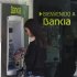 A woman uses a Bankia bank automated teller machine (ATM) in Madrid