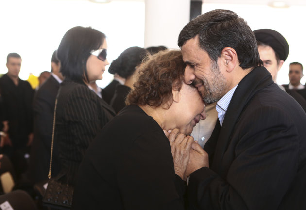 FILE --In this Friday, March 8, 2013 file photo released by the Miraflores Press Office, Iran's President Mahmoud Ahmadinejad comforts Elena Frias next to the flag-draped coffin of her son, Venezuela's late President Hugo Chavez, during the funeral ceremony at the military academy in Caracas, Venezuela. Senior Iranian clerics have criticized President Mahmoud Ahmadinejad for consoling Hugo Chavez's mother with a hug — a physical contact considered a sin under the country's strict Islamic codes. [AP Photo/Miraflores Press Office, File)