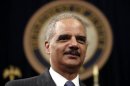 U.S. Attorney General Holder looks on during a special naturalization ceremony at the Department of Justice in Washington