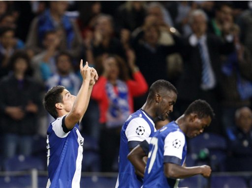 Porto's James celebrates his goal against Paris Saint Germain with teammates during Champions League Group A soccer match in Porto