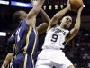 San Antonio Spurs' Tony Parker (9), of France, looks to pass as Indiana Pacers' Sam Young, left, defends during the third quarter of an NBA basketball game, Monday, Nov. 5, 2012, in San Antonio. (AP Photo/Eric Gay)