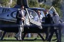 New England Patriots quarterback Tom Brady arrives by helicopter for a speaking event at Salem State University in Salem, Mass., Thursday, May 7, 2015. An NFL investigation has found that New England Patriots employees likely deflated footballs and that quarterback Tom Brady was "at least generally aware" of the rules violations. The 243-page report released Wednesday, May 6, 2015, said league investigators found no evidence that coach Bill Belichick and team management knew of the practice. (AP Photo/Charles Krupa)