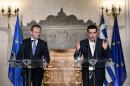 European Council President Donald Tusk (L) and Greek Prime Minister Alexis Tsipras make statements to the press after their meeting in Athens
