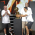 Miami Heat coach Erik Spoelstra, right, grabs the NBA championship trophy as assistant coaches Ron Rothstein, left, and David Frizdale watch, in Miami on Monday, June 25, 2012. Hundred of thousands of people filled the streets of Miami for the Heat championship parade, and then 15,000 more got into the arena afterward for a long, loud reception for the NBA's new kings. (AP Photo/Alan Diaz)