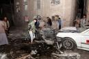 The wreckage of a car is seen at the site of a car bomb attack in the capital Sanaa, on June 29, 2015