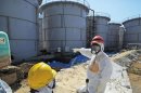 Japan's Economy, Trade and Industry Minister Motegi inspects contaminated water tanks at the tsunami-crippled Fukushima Daiichi nuclear power plant in Fukushima prefecture