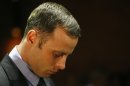 Olympic athlete Oscar Pistorius stands during his bail hearing at the magistrate court in Pretoria, South Africa, Thursday, Feb. 21, 2013. The lead investigator in the murder case against Pistorius faces attempted murder charges himself over a 2011 shooting, police said Thursday in another potentially damaging blow to the prosecution. Prosecutors said they were unaware of the charges against veteran detective Hilton Botha when they put him on the stand in court to explain why Pistorius should not be given bail in the Valentine's Day shooting death of his girlfriend. (AP Photo/Themba Hadebe)