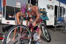 Karen Carner and her husband Mark Lee decorate a bike Tuesday, Aug. 26, 2014, at a Wal-Mart in Reno, Nev. The couple are providing concierge service for two women from Pittsburgh who are first-timers at the festival. Many Burners are delayed after a rare rain storm temporarily closed the entrance to Burning Man yesterday causing long traffic backups. The gates reopened at 6 a.m. Tuesday for the weeklong counter-culture festival that draws 70,000 people to the Black Rock Desert. (AP Photo/Cathleen Allison)